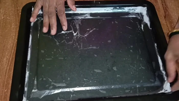 Pour batter into a greased and butter-paper-lined tray. Spread evenly and tap gently.