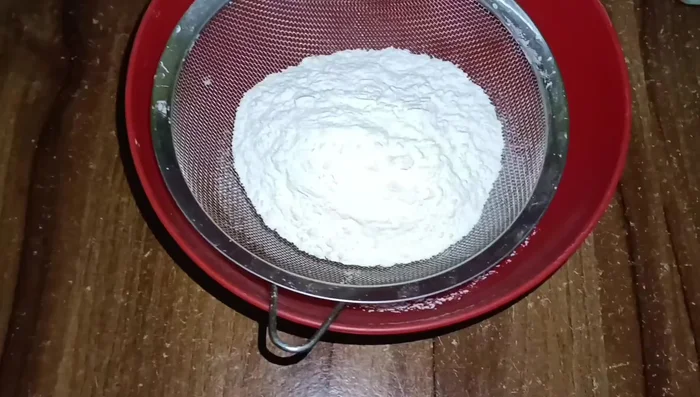 Filter dry ingredients: flour, baking powder, and baking soda.